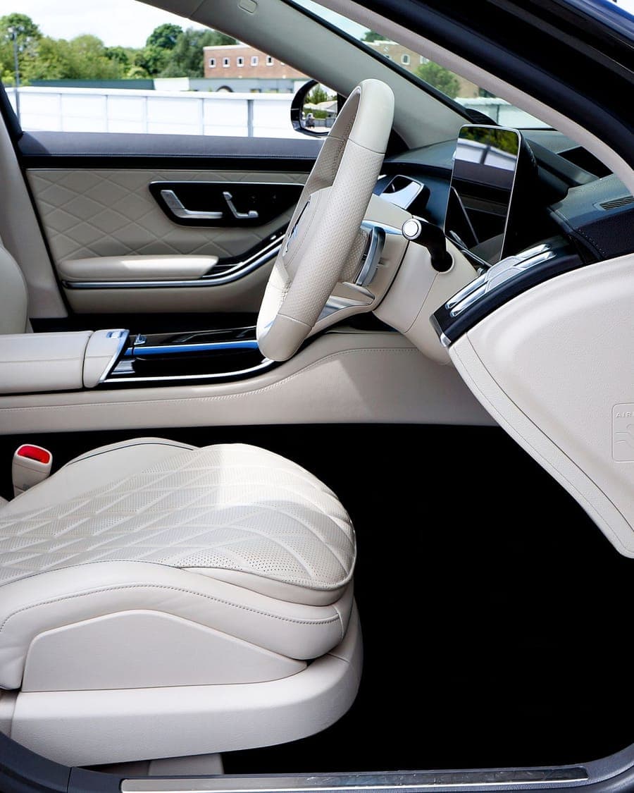 The rear cabin of a Mercedes S-Class with cream quilted leather seats
